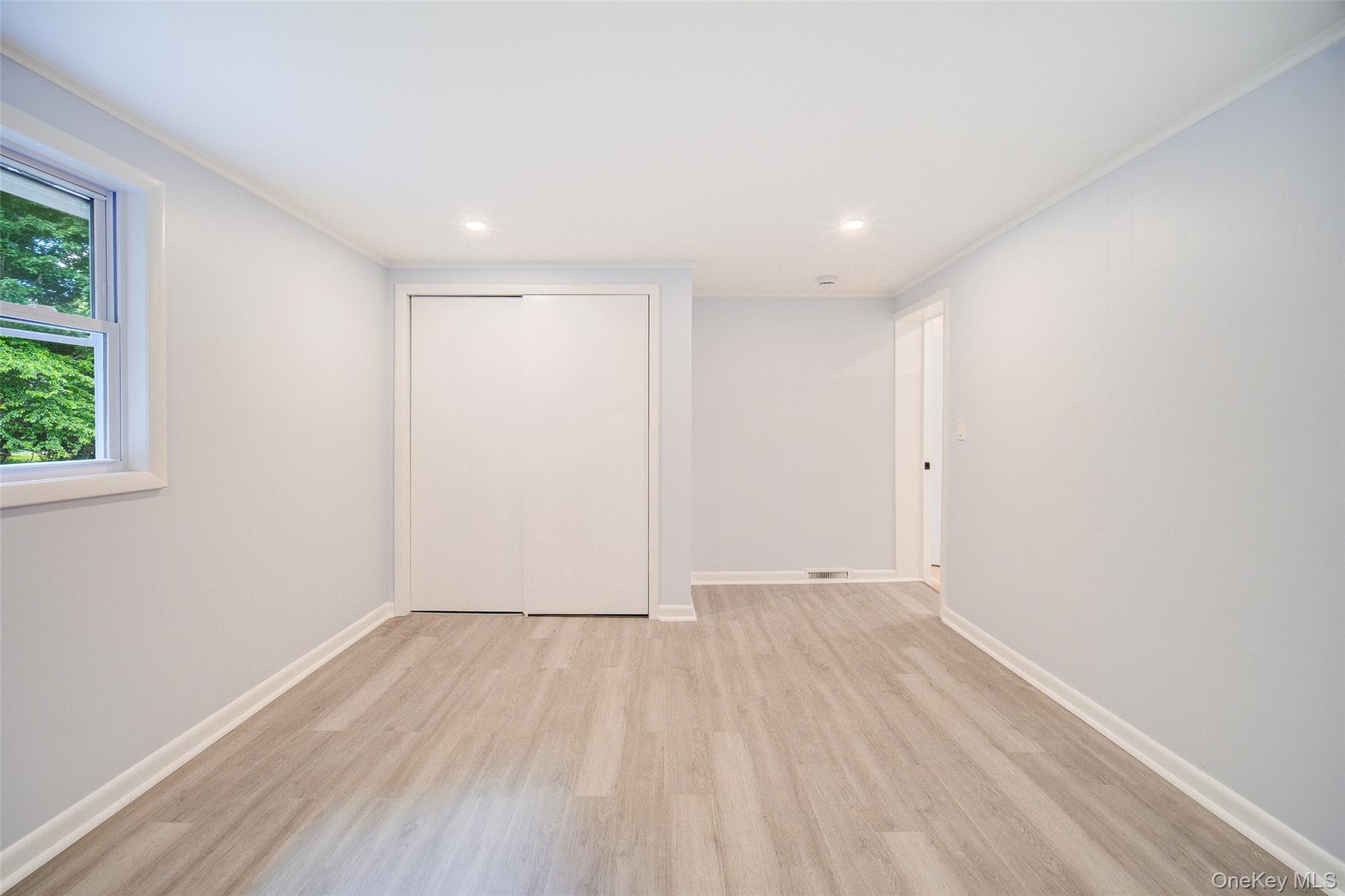 219 Benedict Road Montgomery, NY 12549 - Photo 22 of 50 an empty room with wooden floor and windows