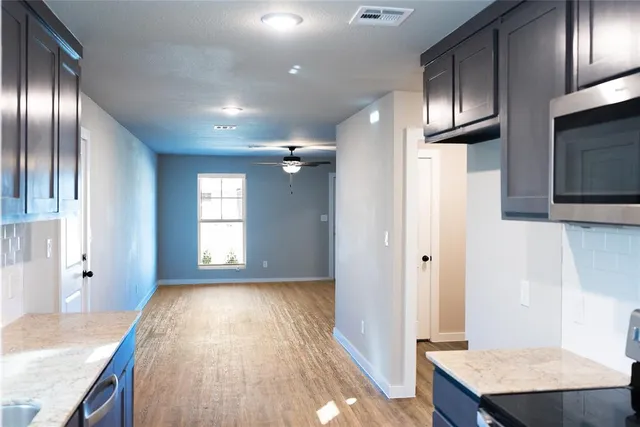 a view of a kitchen from the hallway