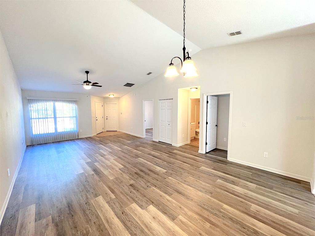 20 Plateau Lane, Unit A Palm Coast, FL 32164 - Photo 12 of 37 a view of an empty room with window and wooden floor