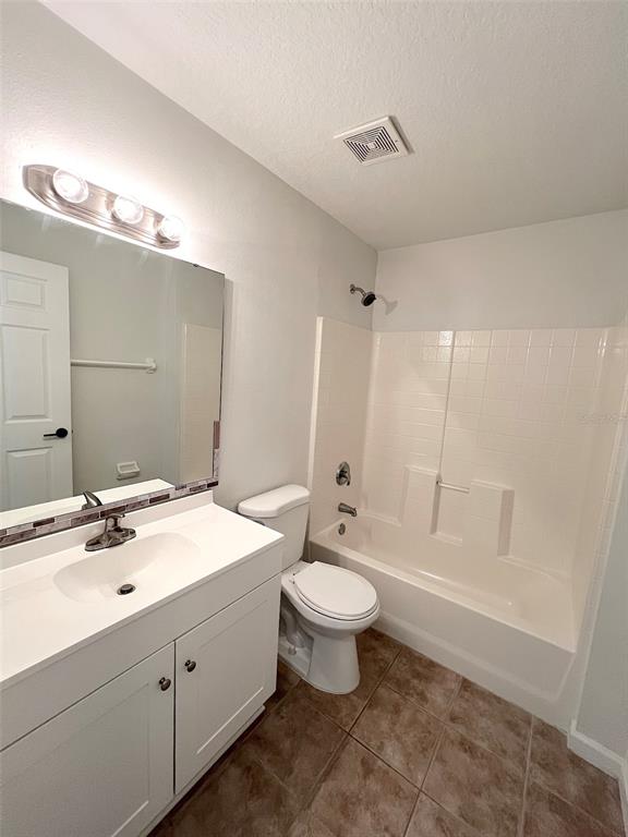 20 Plateau Lane, Unit A Palm Coast, FL 32164 - Photo 27 of 37 a bathroom with a double vanity sink toilet mirror and bathtub