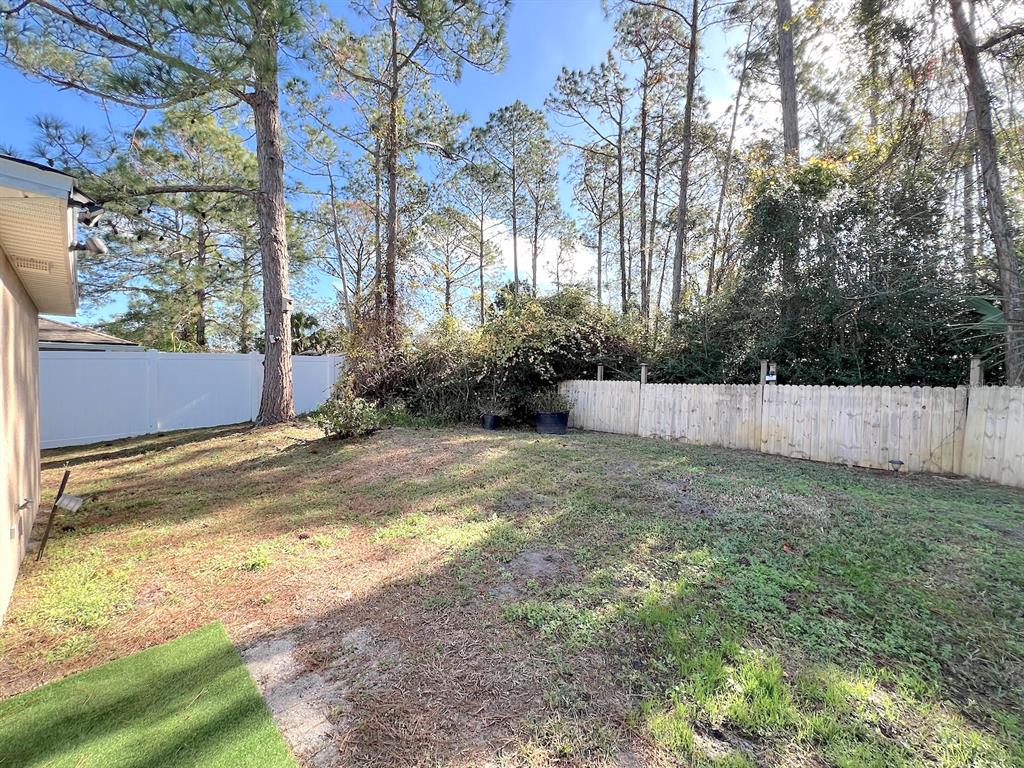20 Plateau Lane, Unit A Palm Coast, FL 32164 - Photo 36 of 37 a view of a backyard with large trees