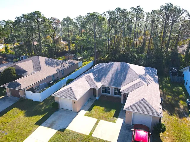 an aerial view of a house with swimming pool and porch