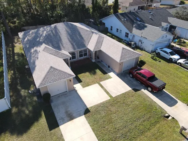 an aerial view of a house with a yard