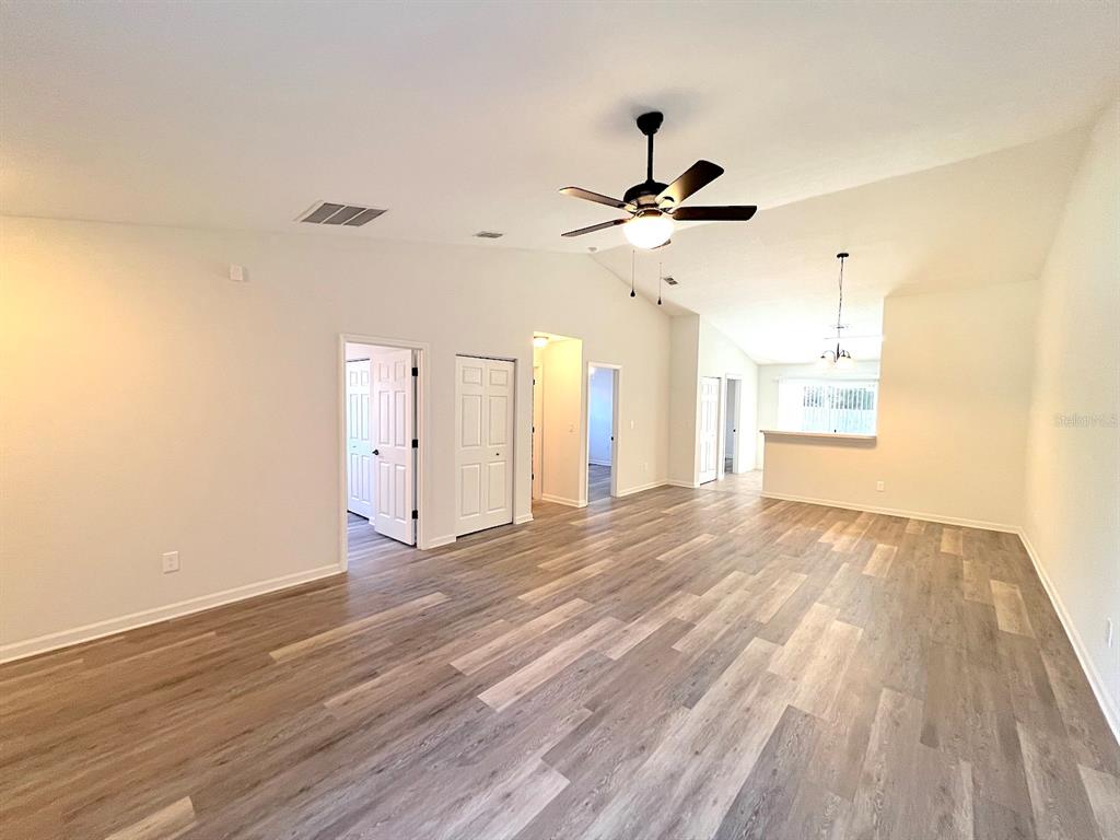 20 Plateau Lane, Unit A Palm Coast, FL 32164 - Photo 10 of 37 a view of a room with wooden floor and ceiling fan