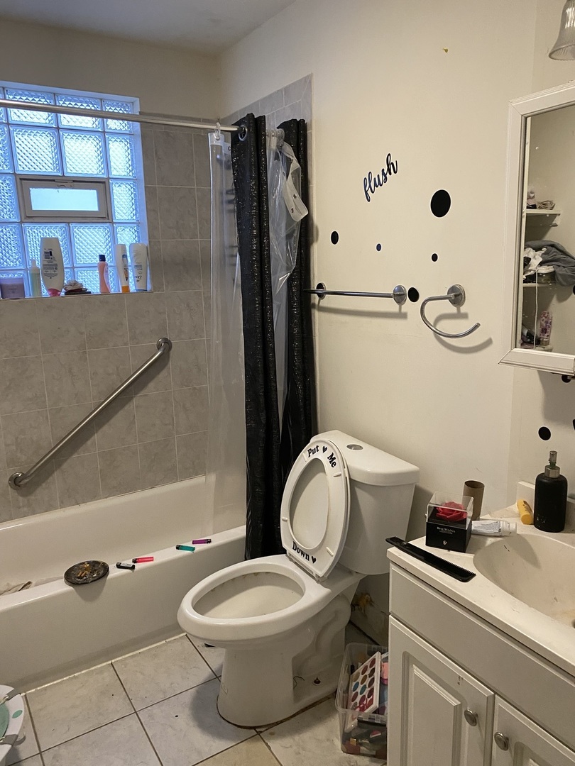 6728 South Normal Boulevard Chicago, IL 60621 - Photo 13 of 14 a bathroom with a granite countertop toilet sink and mirror