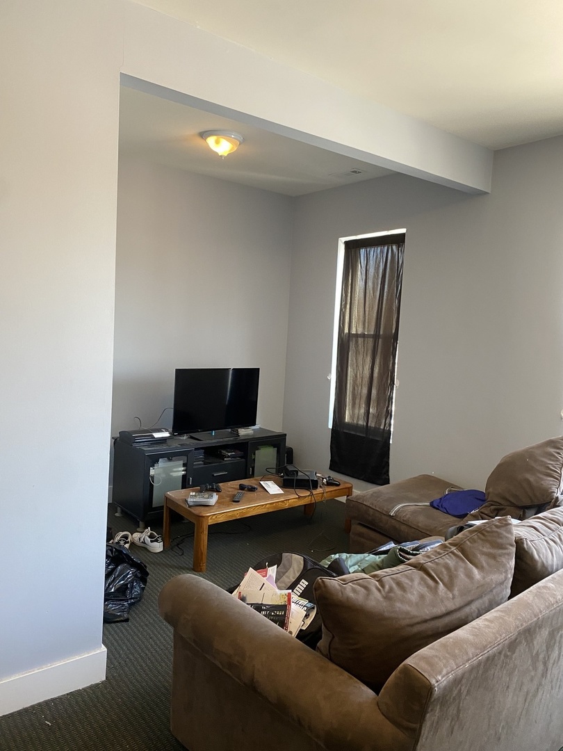 6728 South Normal Boulevard Chicago, IL 60621 - Photo 2 of 14 a living room with furniture and a window