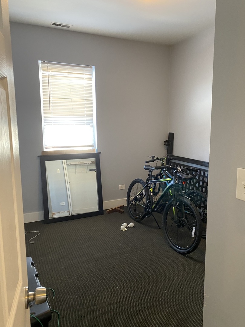 6728 South Normal Boulevard Chicago, IL 60621 - Photo 6 of 14 a view of a room with rack and a window