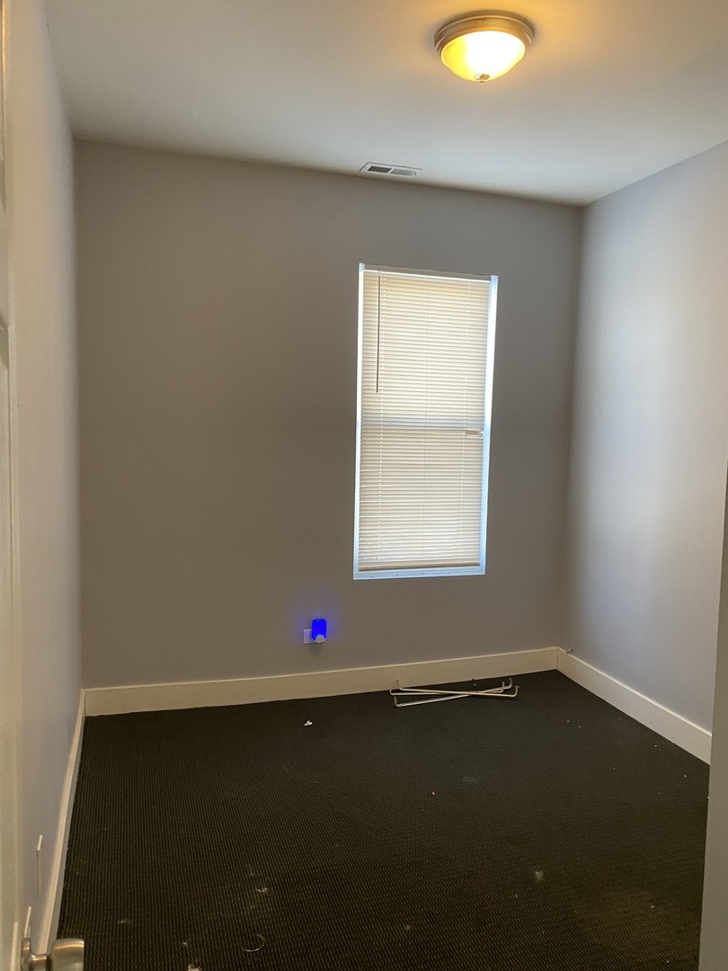 6728 South Normal Boulevard Chicago, IL 60621 - Photo 7 of 14 an empty room with a window