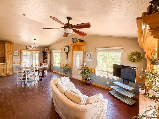 425 East Mule Deer Road Central, UT 84722 - Photo 4 of 72 Living area featuring dark wood finished floors, a textured ceiling, lofted ceiling, a ceiling fan, and baseboards