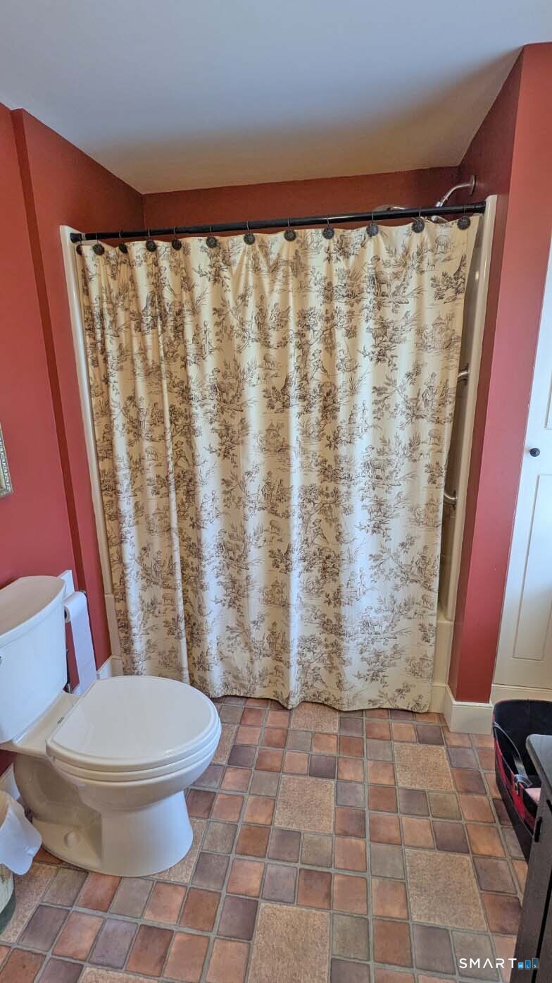 355 Wall Street Hebron, CT 06248 - Photo 18 of 39 a white toilet sitting next to a shower curtain
