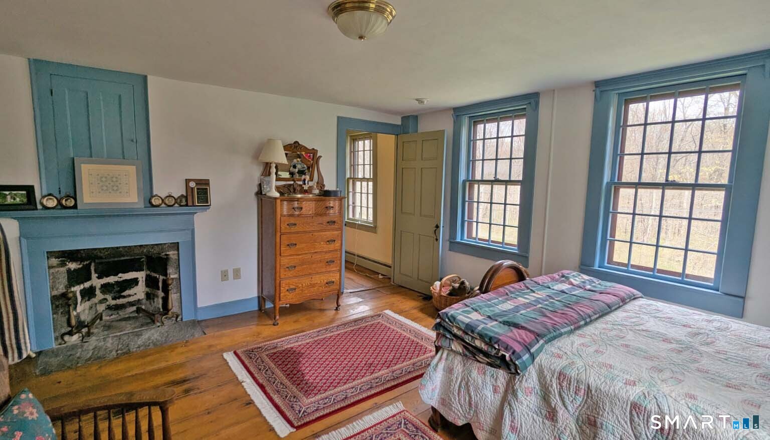 355 Wall Street Hebron, CT 06248 - Photo 22 of 39 a bedroom with a bed and a fireplace