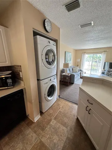 a view of a storage and utility room with washer and dryer