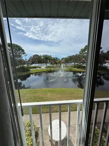 a view of balcony with wooden floor and lake view