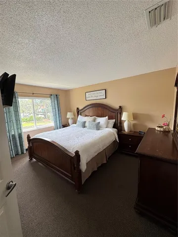 a bedroom with bed and window