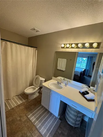 a room with a table chairs and appliances