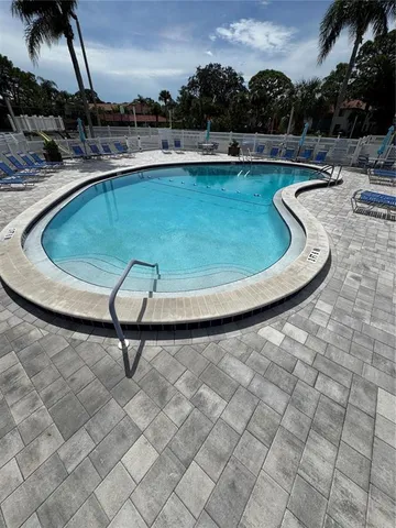 a view of a swimming pool with a yard