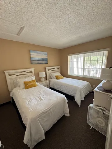 a bedroom with two beds and a window