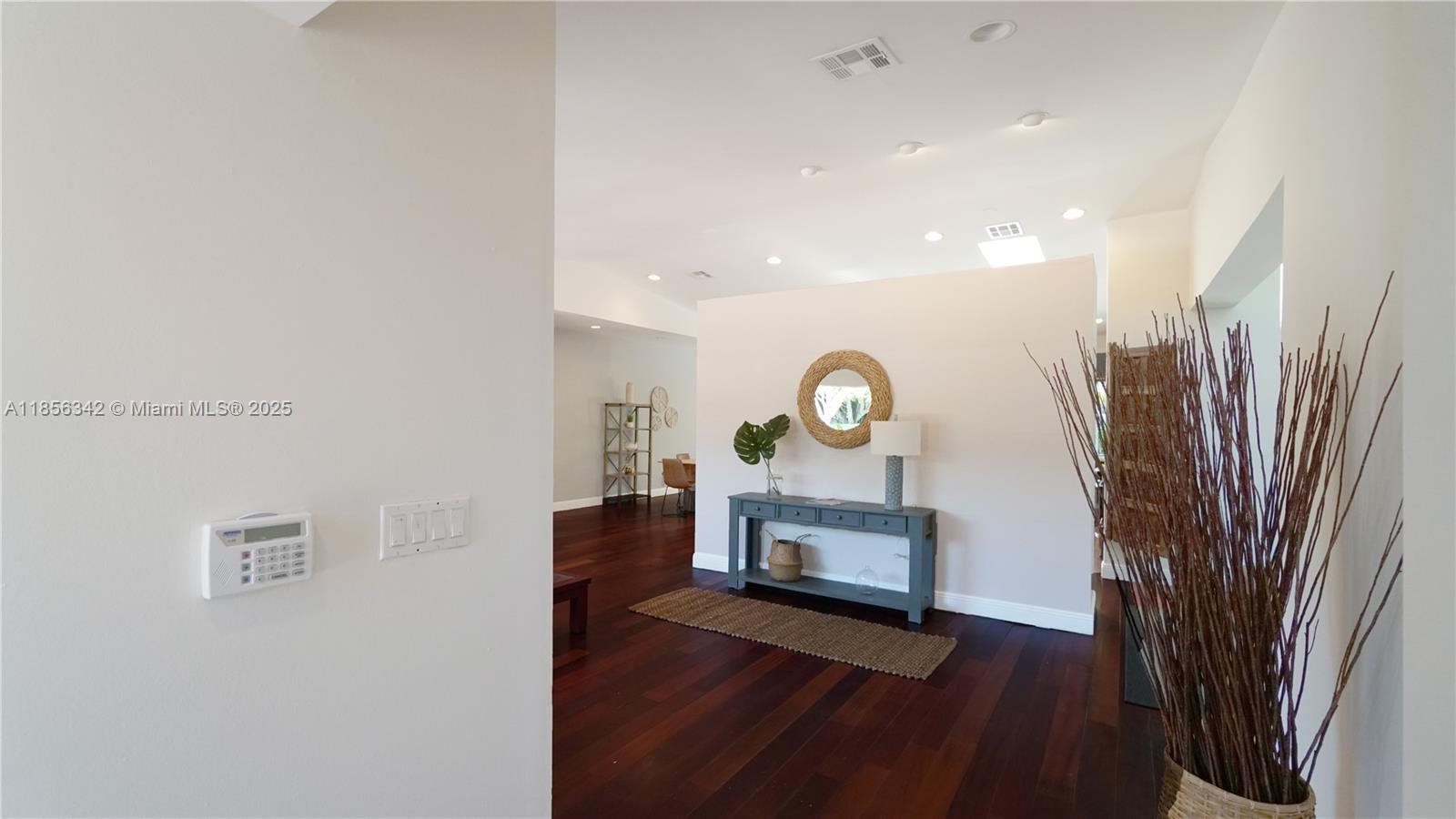 691 Ridgewood Road Key Biscayne, FL 33149 - Photo 11 of 67 a view of a livingroom with furniture and a bookshelf