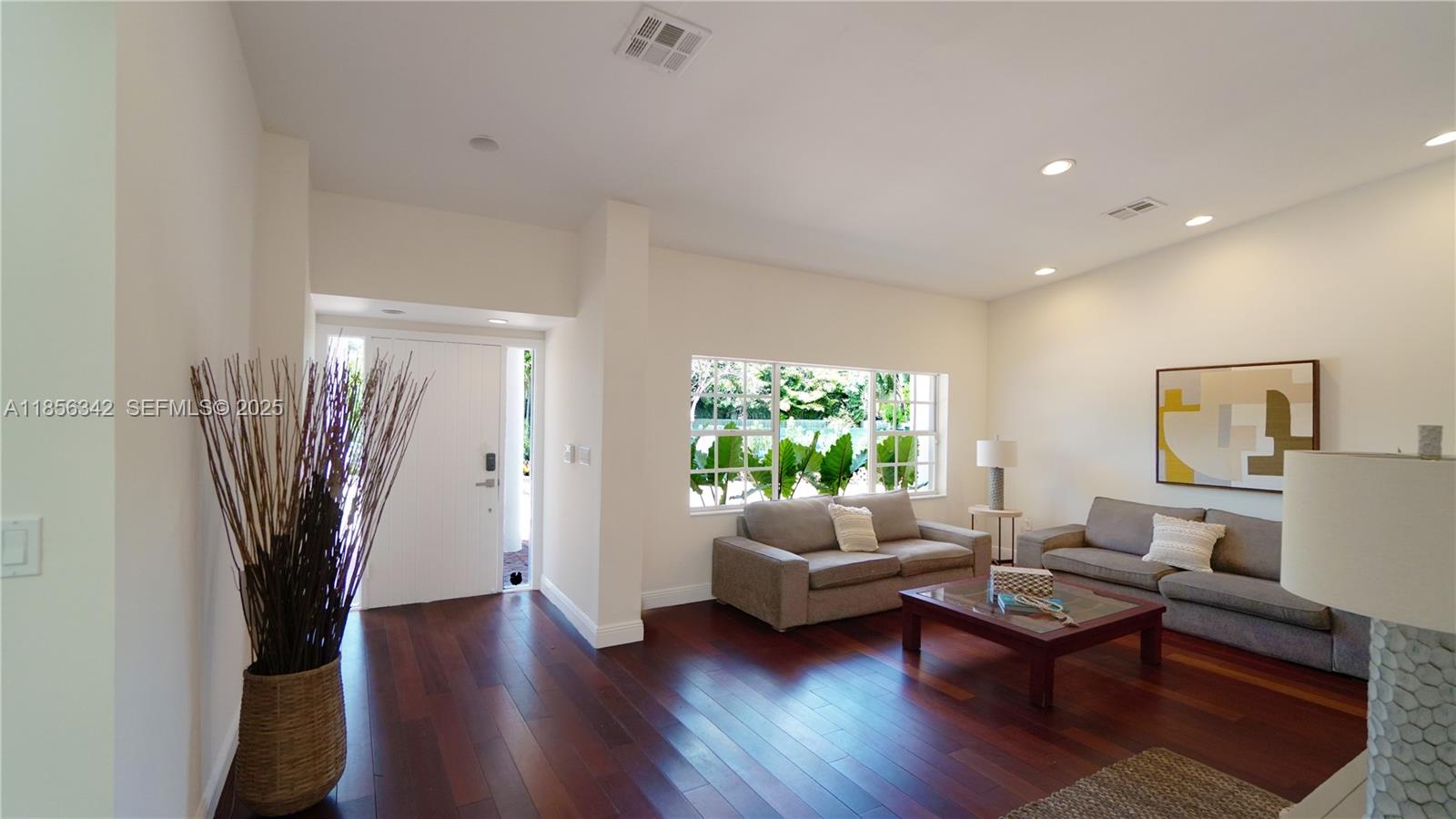 691 Ridgewood Road Key Biscayne, FL 33149 - Photo 12 of 67 a living room with furniture and a potted plant