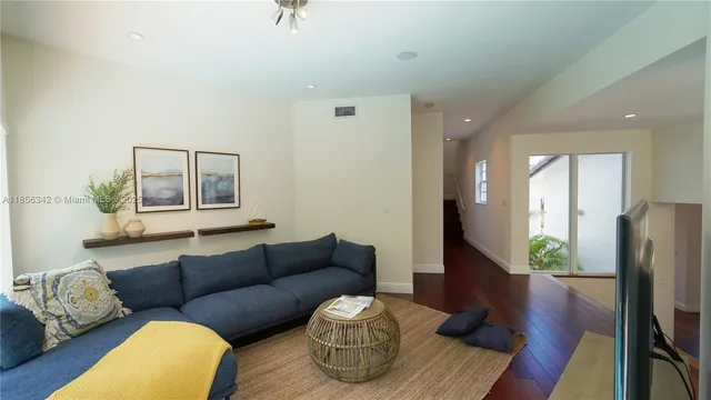 a kitchen with a sink and wooden floor