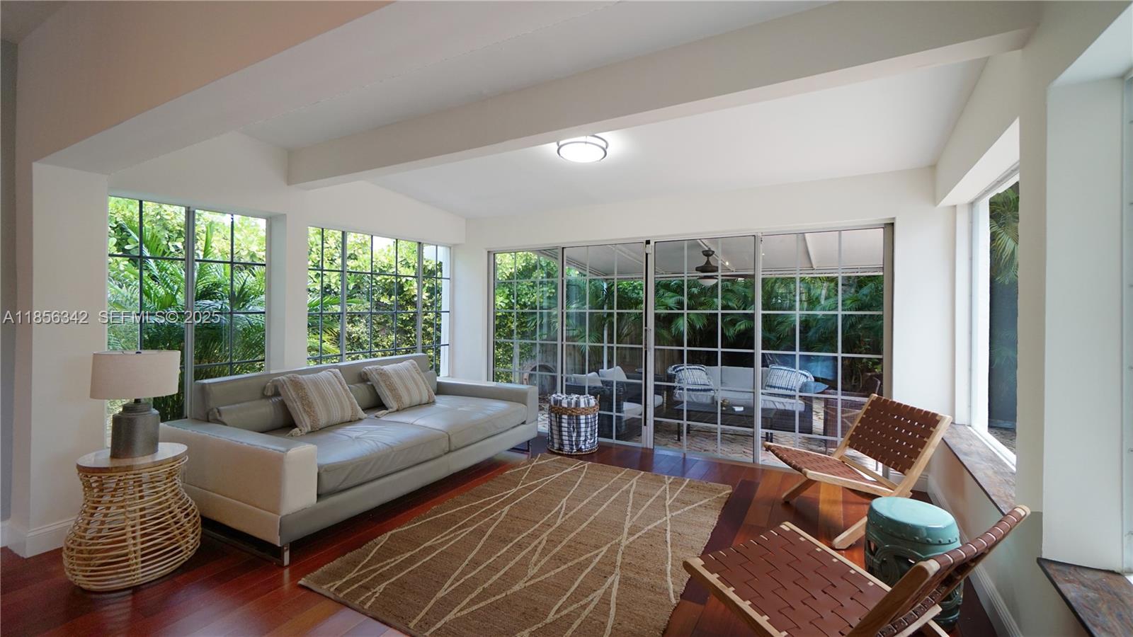691 Ridgewood Road Key Biscayne, FL 33149 - Photo 24 of 67 a living room with furniture and a large window