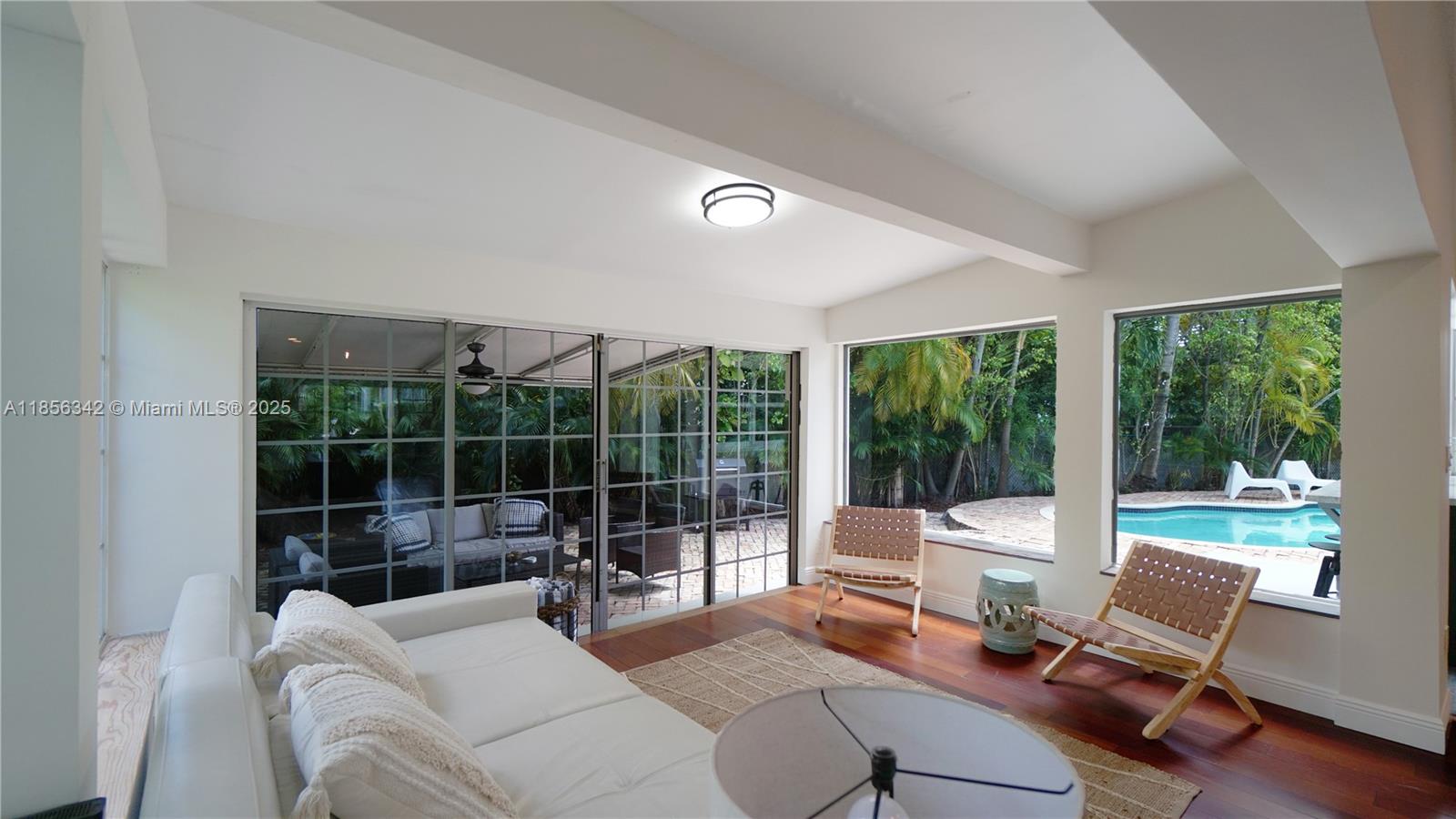 691 Ridgewood Road Key Biscayne, FL 33149 - Photo 25 of 67 a living room with furniture and a large window