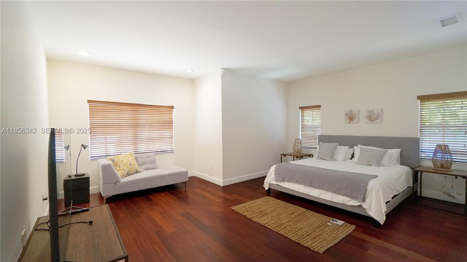 691 Ridgewood Road Key Biscayne, FL 33149 - Photo 27 of 67 a bedroom with a bed and a couch