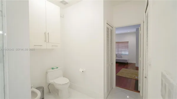 a bathroom with a shower sink and mirror