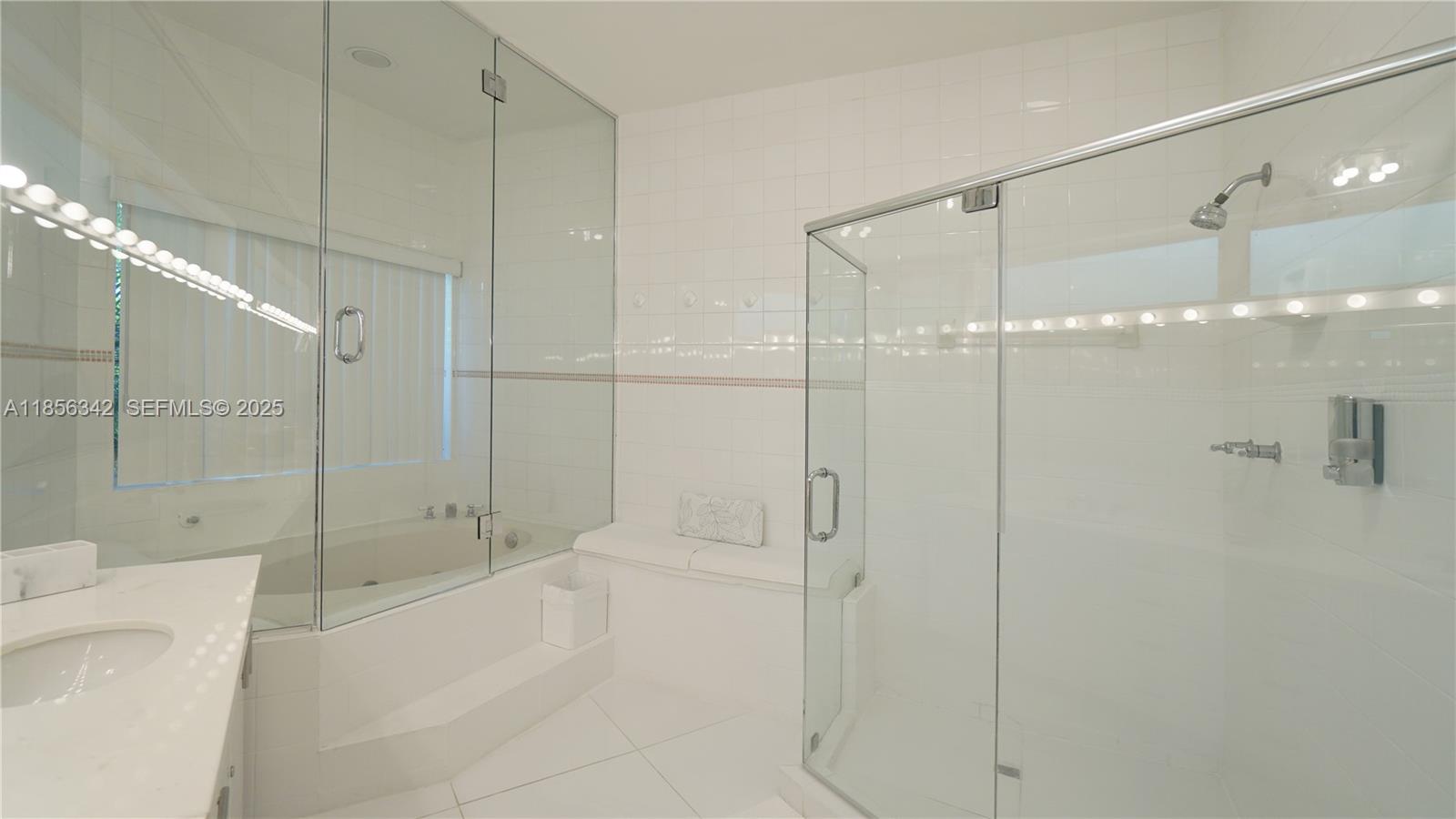 691 Ridgewood Road Key Biscayne, FL 33149 - Photo 33 of 67 a bathroom with a shower and a tub