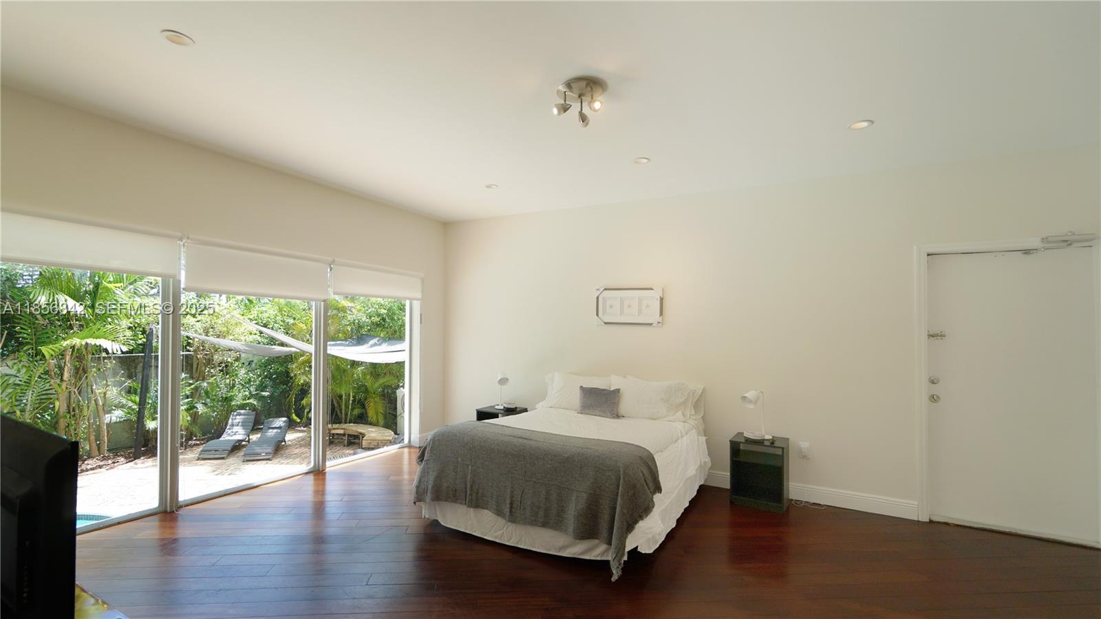 691 Ridgewood Road Key Biscayne, FL 33149 - Photo 35 of 67 a bedroom with a bed and a large window