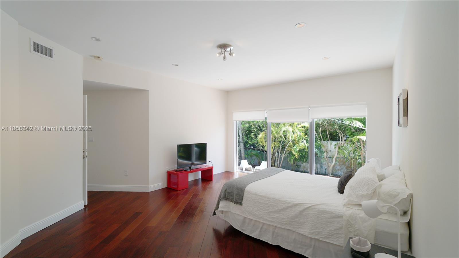 691 Ridgewood Road Key Biscayne, FL 33149 - Photo 36 of 67 a bed room with a bed and a large window