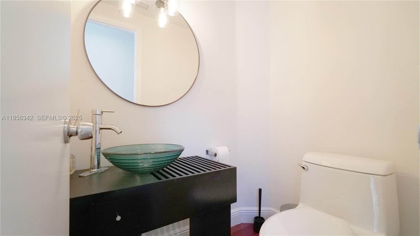 691 Ridgewood Road Key Biscayne, FL 33149 - Photo 41 of 67 a bathroom with a sink and a mirror