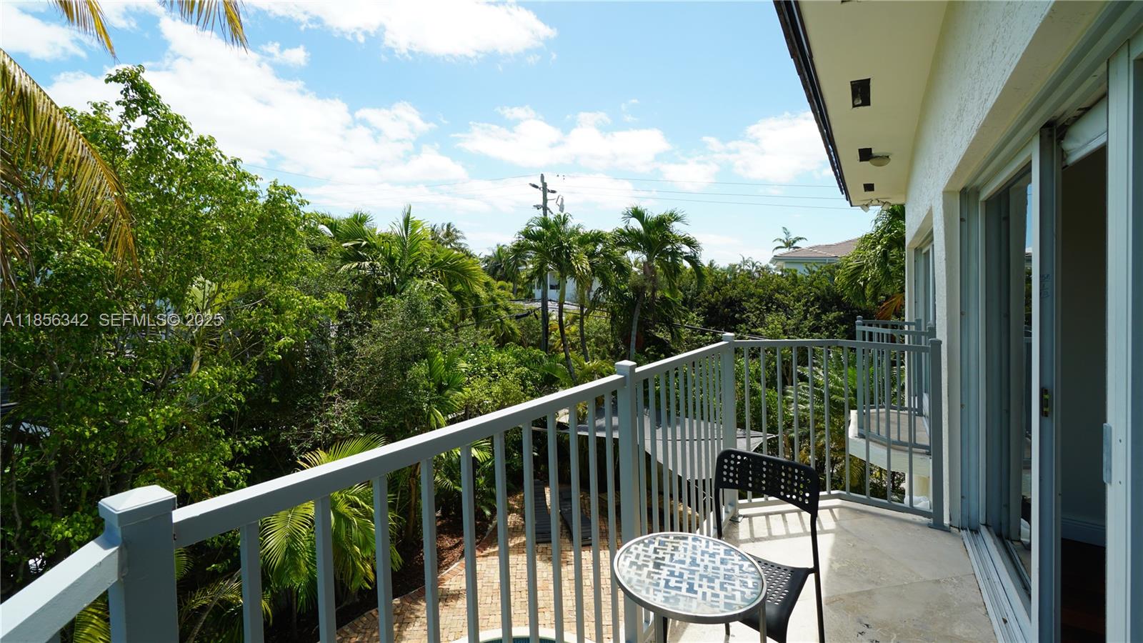 691 Ridgewood Road Key Biscayne, FL 33149 - Photo 53 of 67 a view of a chair and table in the balcony