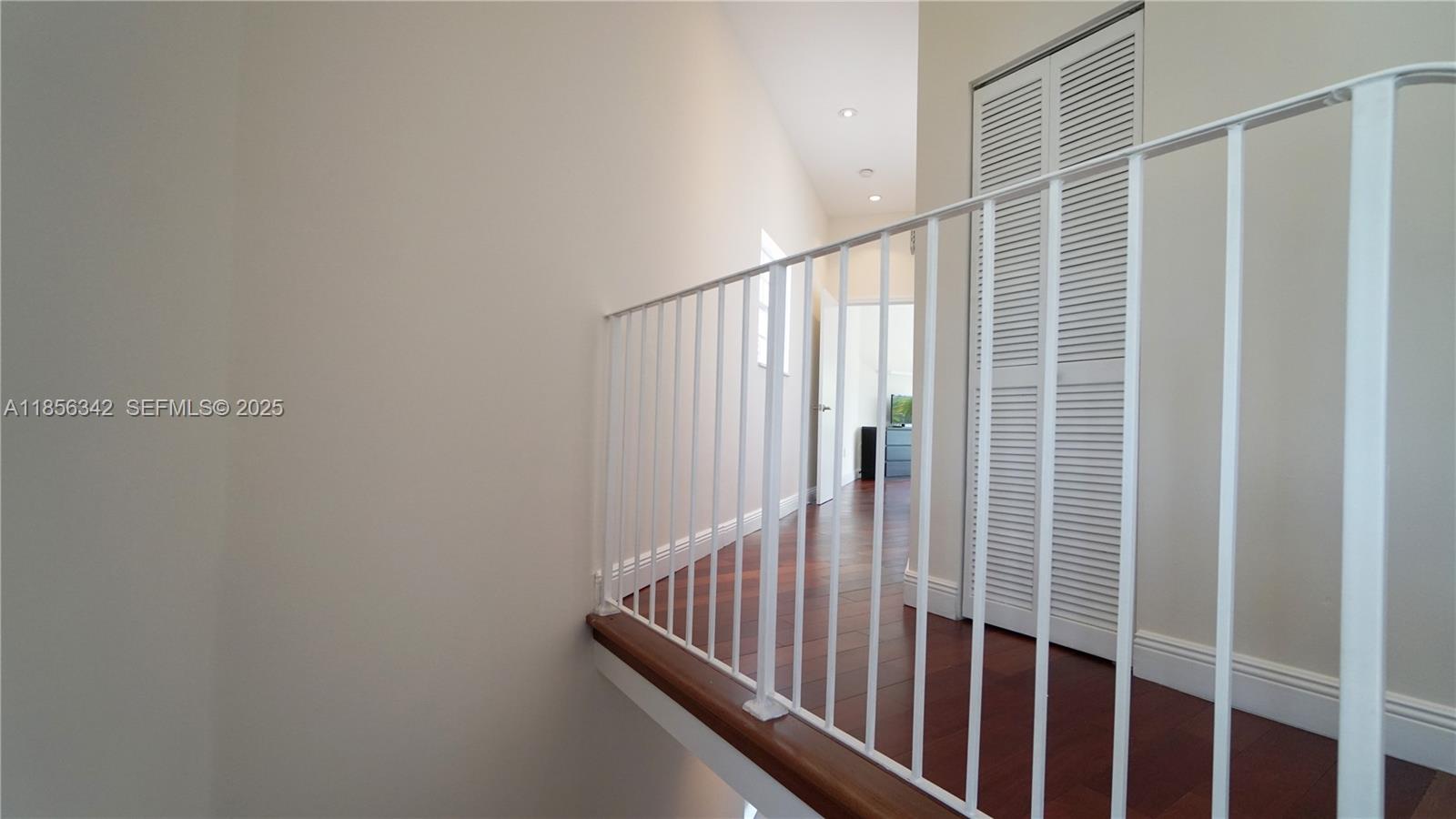 691 Ridgewood Road Key Biscayne, FL 33149 - Photo 56 of 67 a view of staircase with railing and white walls