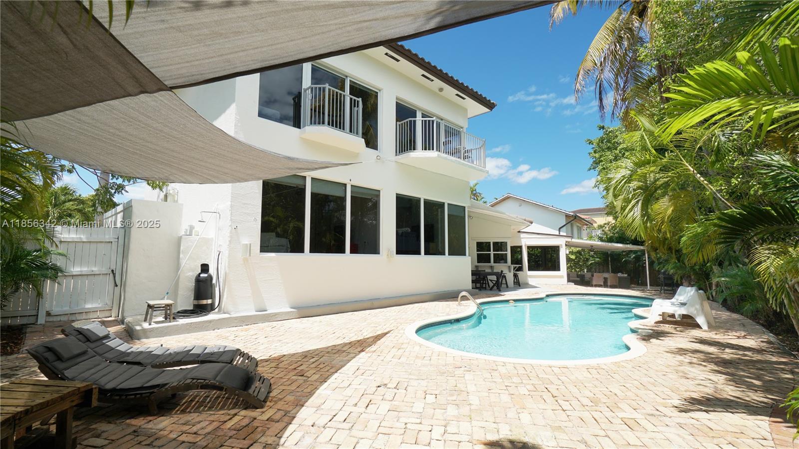 691 Ridgewood Road Key Biscayne, FL 33149 - Photo 65 of 67 a view of a house with backyard and sitting area