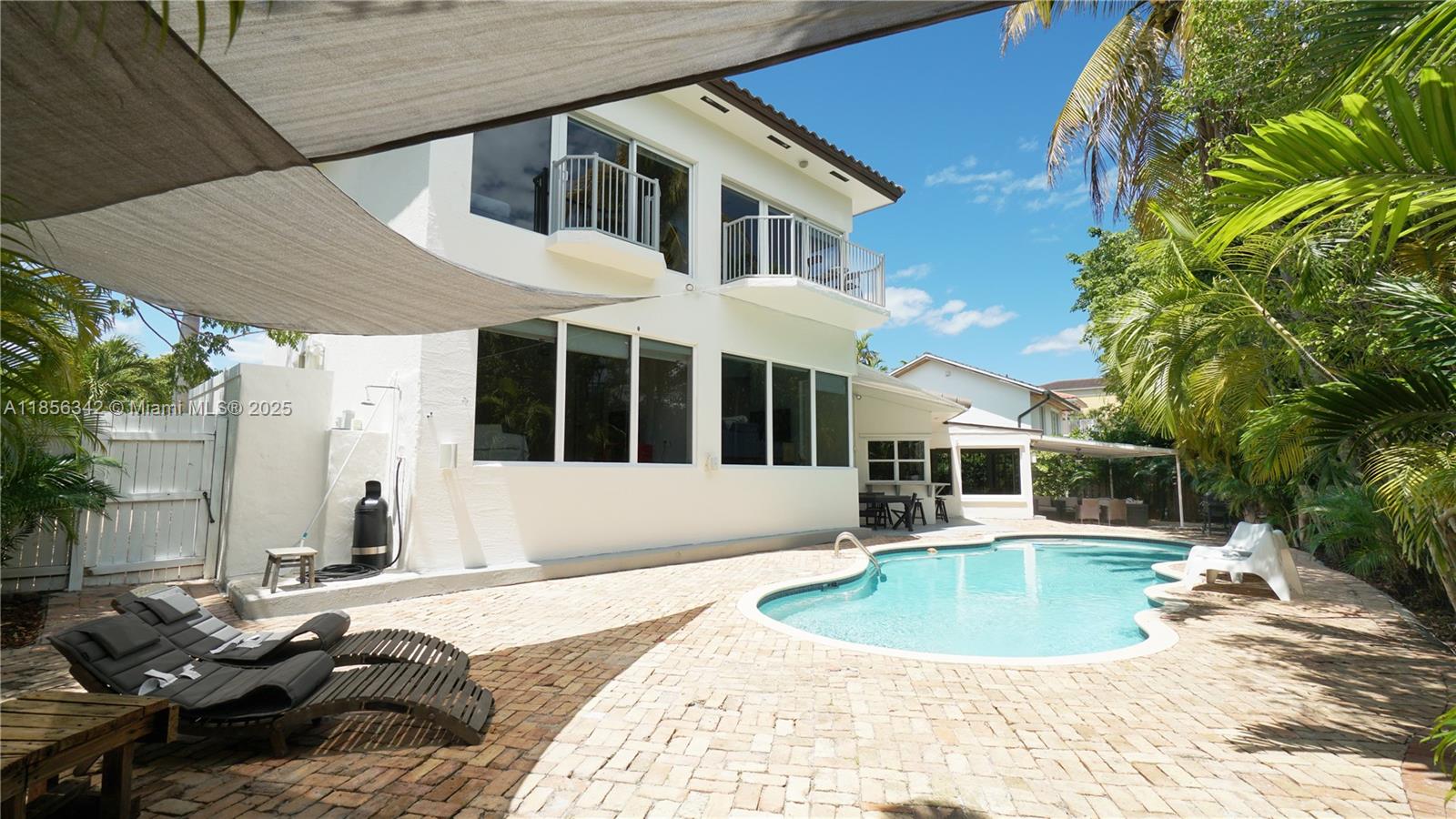 691 Ridgewood Road Key Biscayne, FL 33149 - Photo 66 of 67 a view of a house with backyard and sitting area