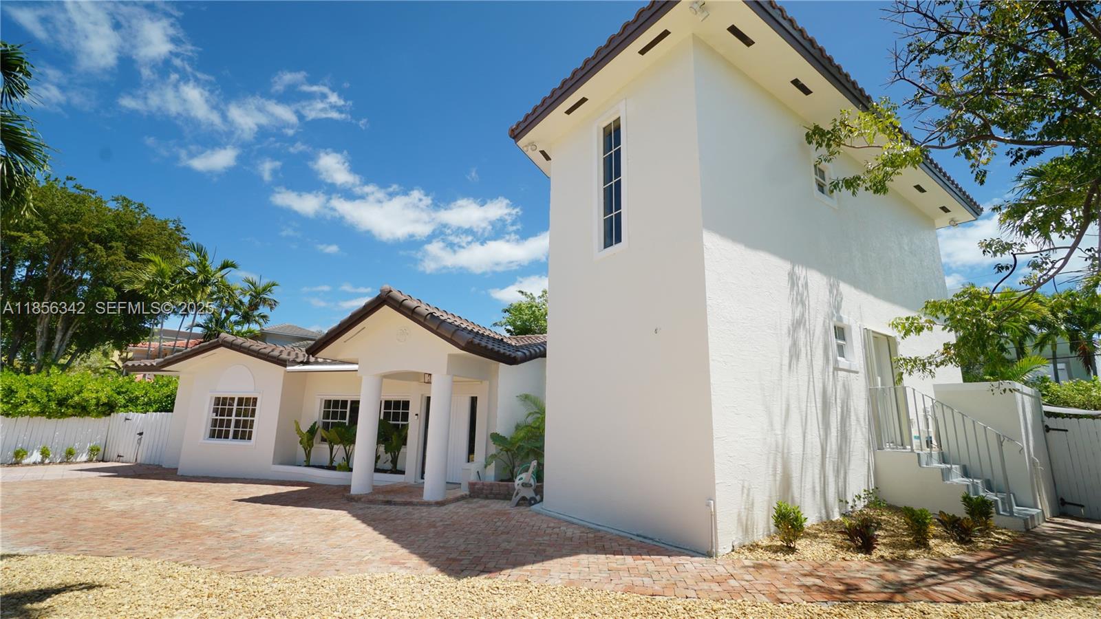 691 Ridgewood Road Key Biscayne, FL 33149 - Photo 7 of 67 a front view of a house with a yard