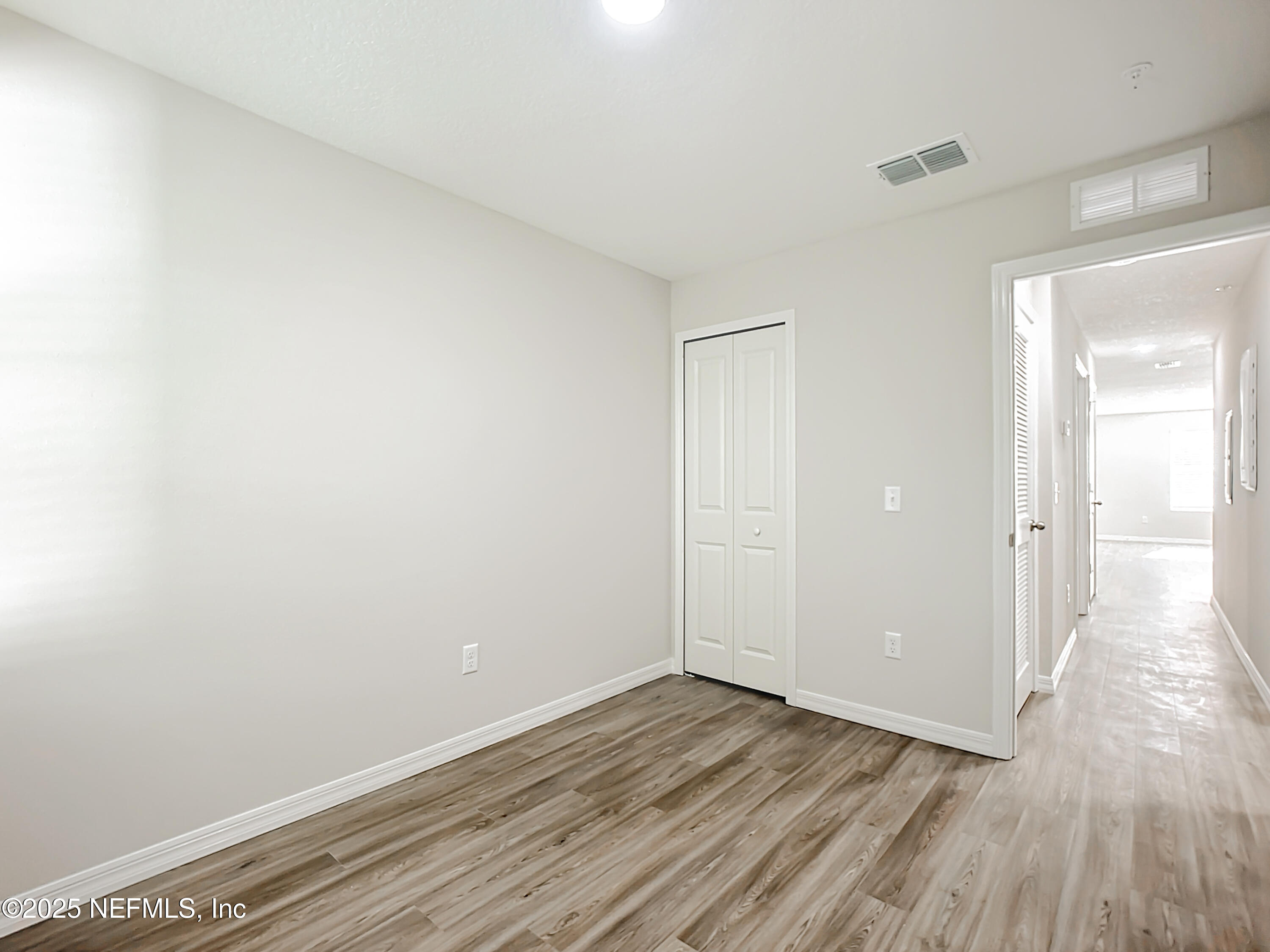 5669 George Court, Unit 101 Jacksonville, FL 32277 - Photo 4 of 10 a view of an empty room and wooden floor