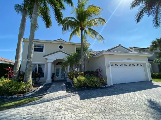a view of a house with a palm tree
