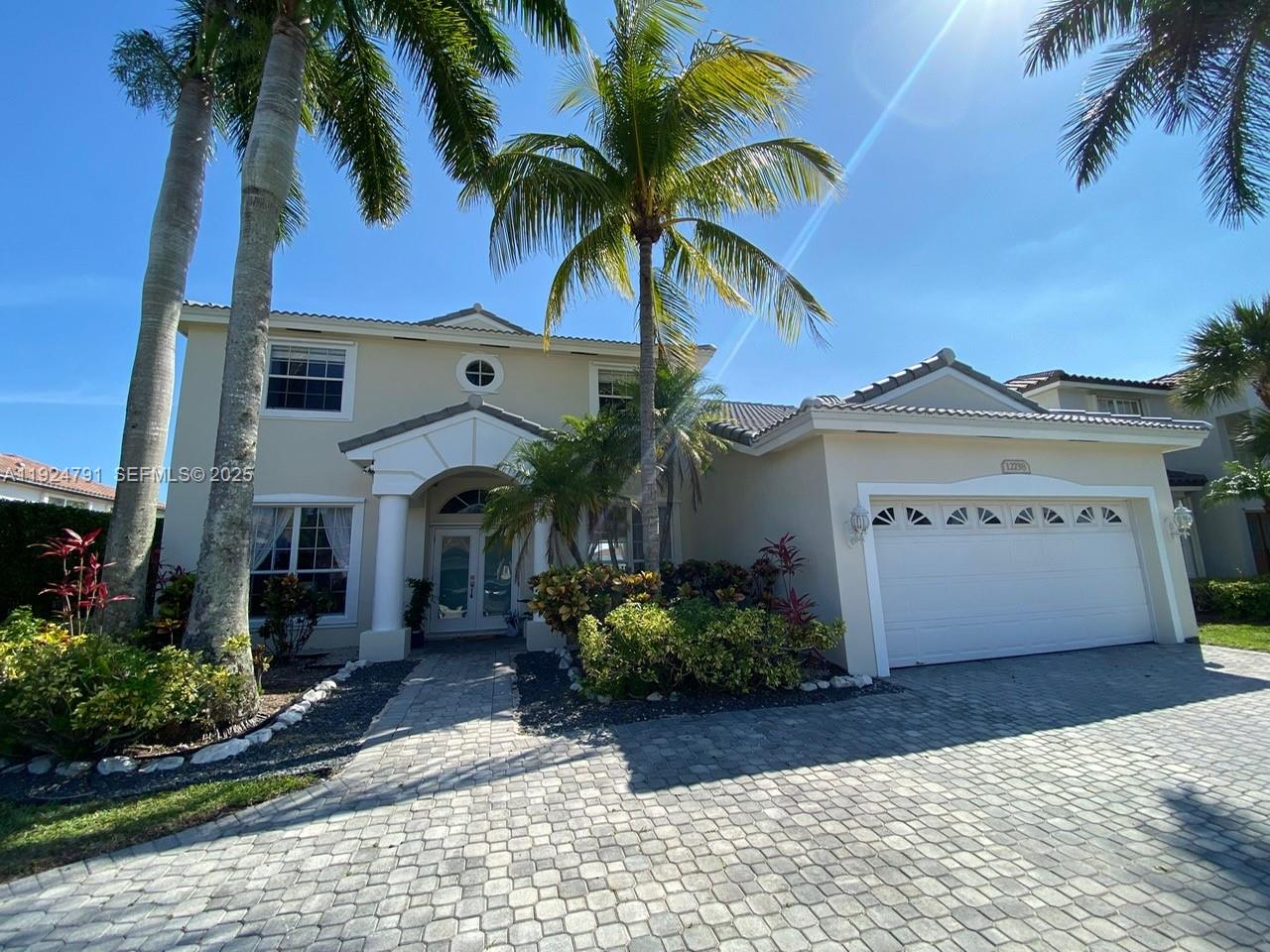 a view of a house with a palm tree