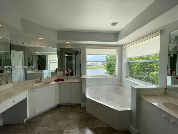 an empty room with wooden floor and fan