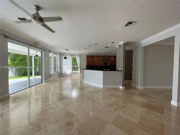 a kitchen with stainless steel appliances granite countertop a sink refrigerator and cabinets