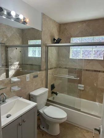 a bathroom with a toilet sink and shower