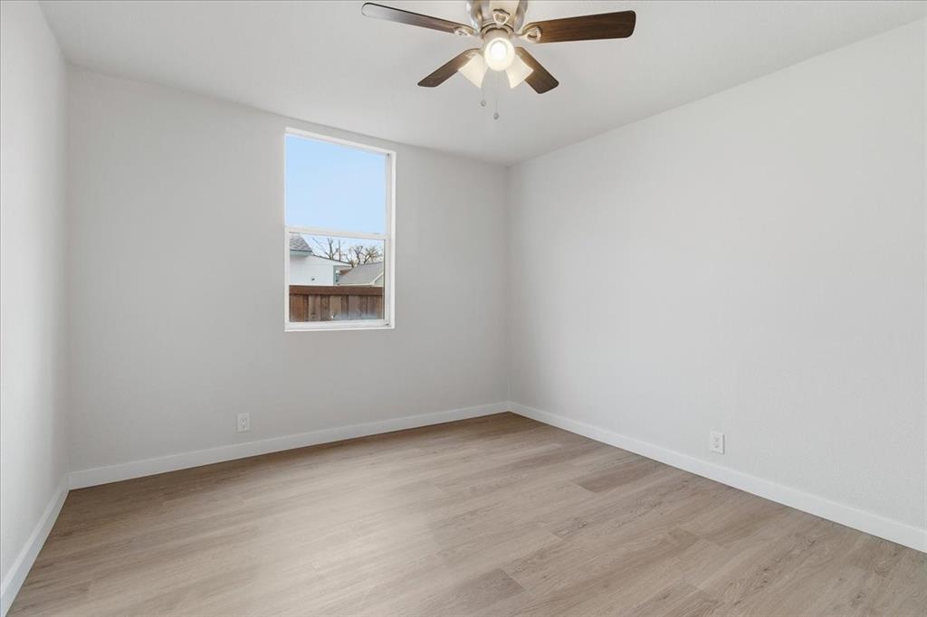 404 South Murray Street McKinney, TX 75069 - Photo 12 of 23 an empty room with a window and a ceiling fan