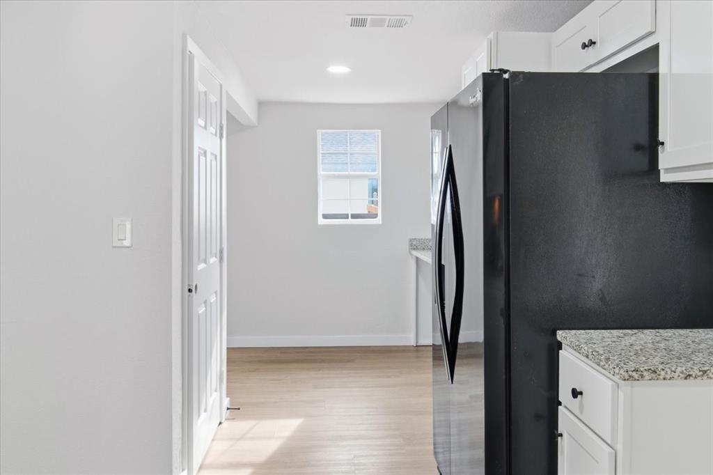 404 South Murray Street McKinney, TX 75069 - Photo 15 of 23 a view of cabinets with refrigerator