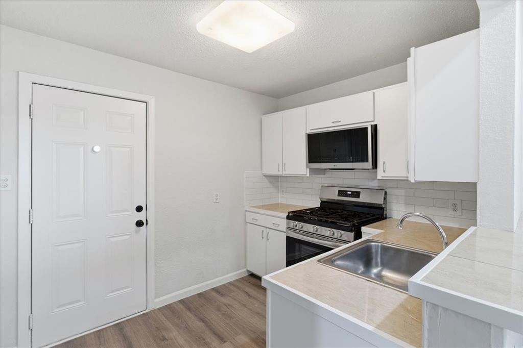 404 South Murray Street McKinney, TX 75069 - Photo 23 of 23 a kitchen that has a sink and a stove in it