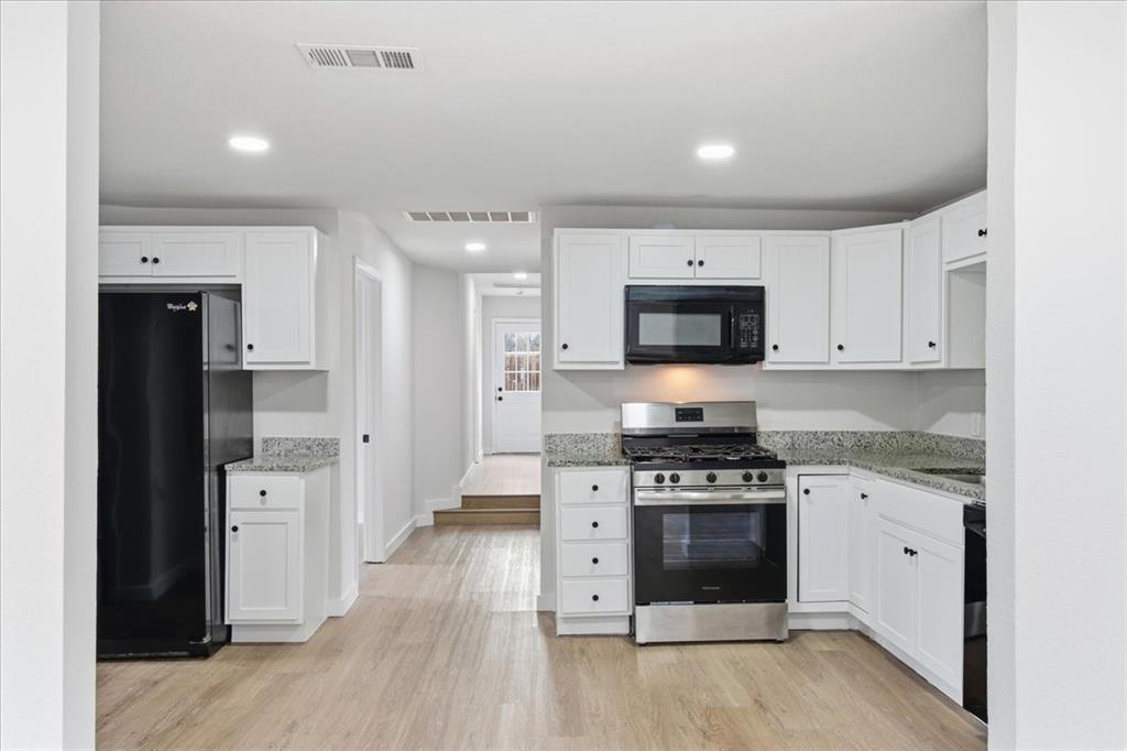 404 South Murray Street McKinney, TX 75069 - Photo 6 of 23 a kitchen with stainless steel appliances a stove top oven and refrigerator