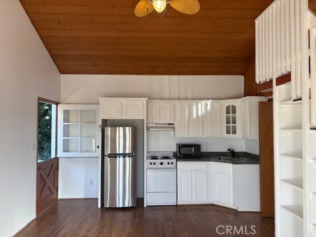 a kitchen with stainless steel appliances granite countertop a refrigerator and a stove