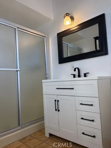 a bathroom with a sink vanity and mirror