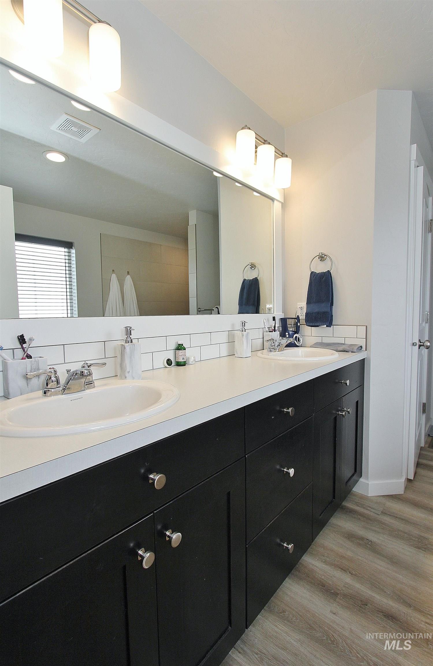 1211 Mahogany Street Parma, ID 83660 - Photo 11 of 22 Bathroom featuring double vanity and light wood-style floors